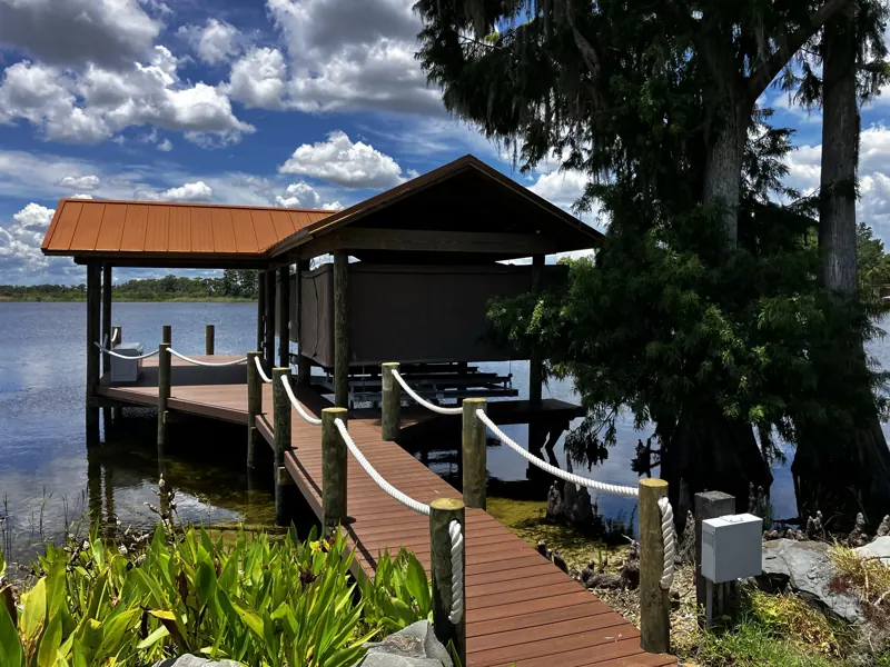 Boathouse with a metal roof and rope-rail walkway