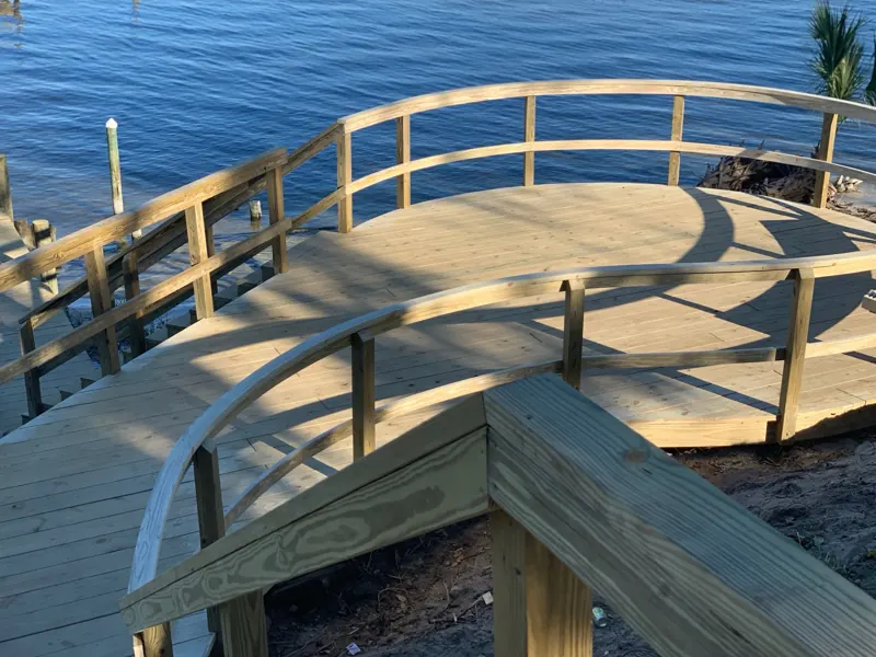 Curved waterfront deck with bent railing